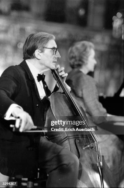British conductor and cellist Sir John Barbirolli during a rehearsal for the King's Lynn Festival. Lady Ruth Fermoy is at the piano.