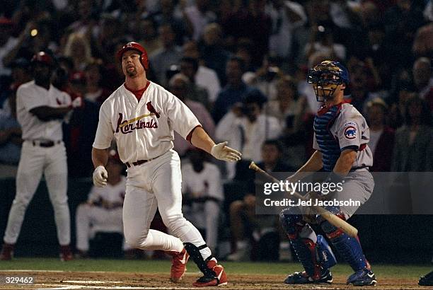 Mark McGwire of the St. Louis Cardinals hits his 62nd home run during the game against the Chicago Cubs at the Busch Stadium in St. Louis, Missouri....