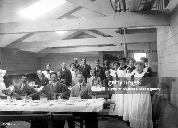 Stewards in a dining room wait to attend the inquiry into the sinking of the 'Titanic'.