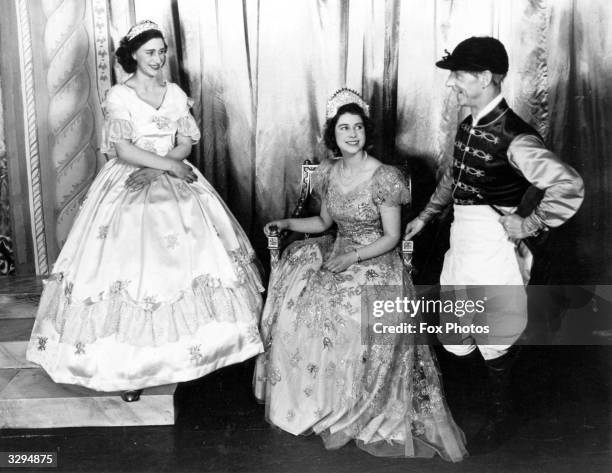 Queen Elizabeth II as Princess Elizabeth, and her sister Princess Margaret Rose in their costumes for a performance of 'Old Mother Red Riding Boots'....