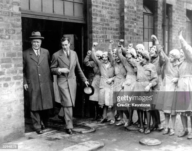 Prince George, , Duke of Kent and youngest son of King George V and Queen Mary, is cheered by workers during a visit to the Carron Ironworks at...