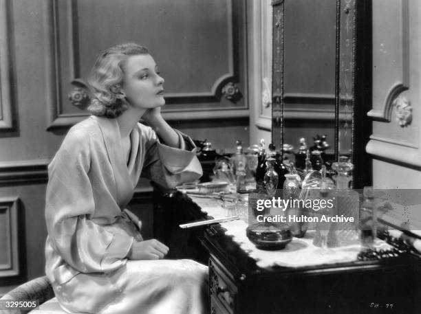 Helen Chandler , the American leading lady who retired early from Hollywood, sitting in reflective mood at her dressing table in a scene from 'The...