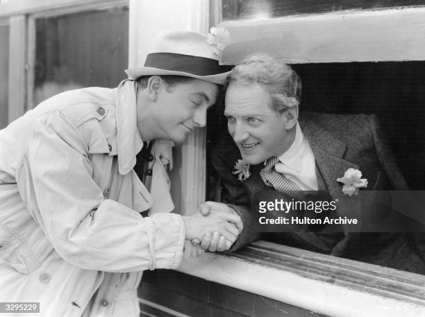 American actors Robert Young and Otto Kruger shaking hands in a scene from the film 'Paris Interlude'. Title: Paris Interlude Studio: Metro Goldwyn...