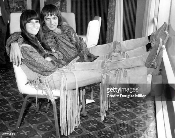 American hit singing duo Sonny and Cher , in London to promote their current discs, relax at the Hilton Hotel. Their single 'I Got You Babe' is...