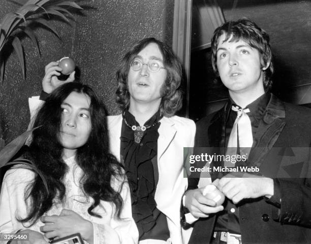 Beatle John Lennon and his Japanese girlfriend Yoko Ono with Beatle Paul McCartney, right, at the premiere of the new Beatles film 'Yellow Submarine'...