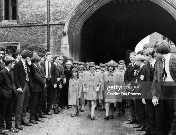 Some of the first batch of girls to be admitted as pupils of the 1000-year-old King's School at Ely, Cambridgeshire, arrive at the school in their...