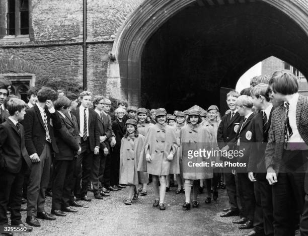 Some of the first batch of girls to be admitted as pupils of the 1000-year-old King's School at Ely, Cambridgeshire, arrive at the school in their...
