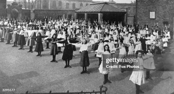 Pupils at drill in neat rows at a boarding school in 1908.