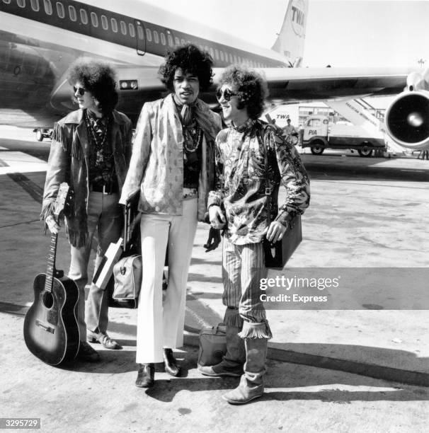 Popular rock trio the Jimi Hendrix Experience at London Airport with their hand luggage. They are, from left to right; Noel Redding , bass player,...