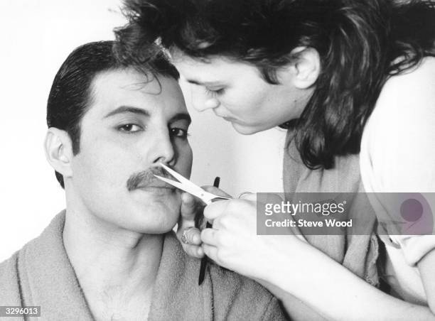 Rock singer Freddie Mercury , of the popular British group Queen, has his moustache groomed.