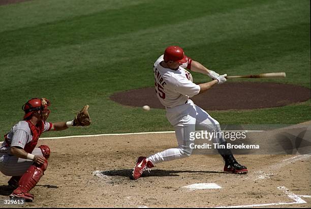 Mark McGwire of the St. Louis Cardinals swings at a pitch and strikes out during a game against the Cincinnati Reds, in which McGwire hit his 60th...