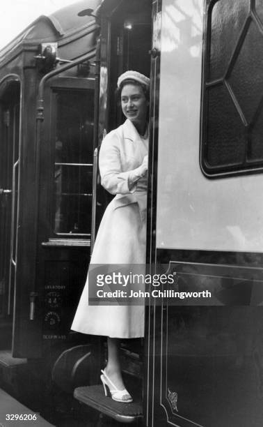 Princess Margaret Rose boards a train at Southampton station after a visit to Southampton Stadium, where she received contributions for the YWCA....