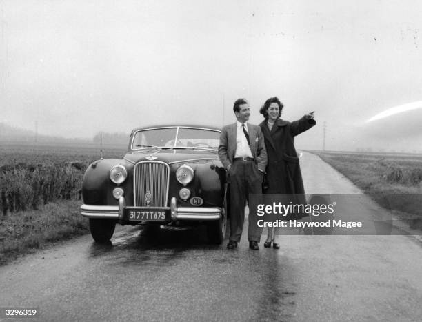 King Peter of Yugoslavia and Queen Alexandra in exile with their car near Paris where they have settled. Original Publication: Picture Post - 7505 -...