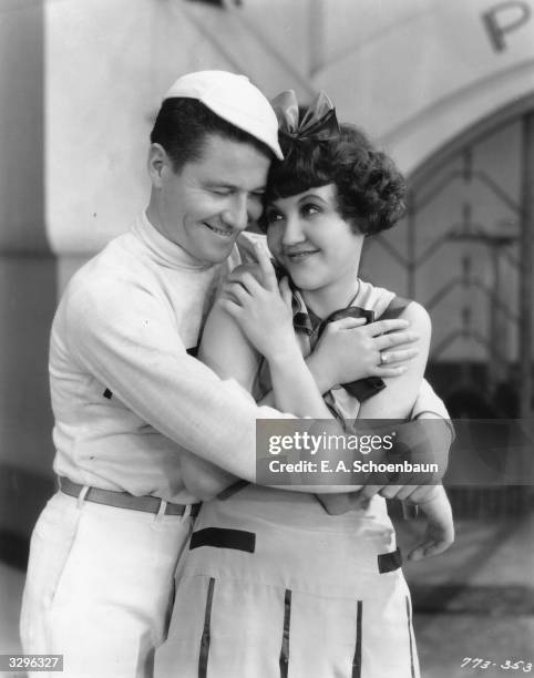 Hollywood actress Zelma O'Neal having a cuddle with American comic actor Jack Oakie in the star-studded musical revue 'Paramount On Parade'. The host...