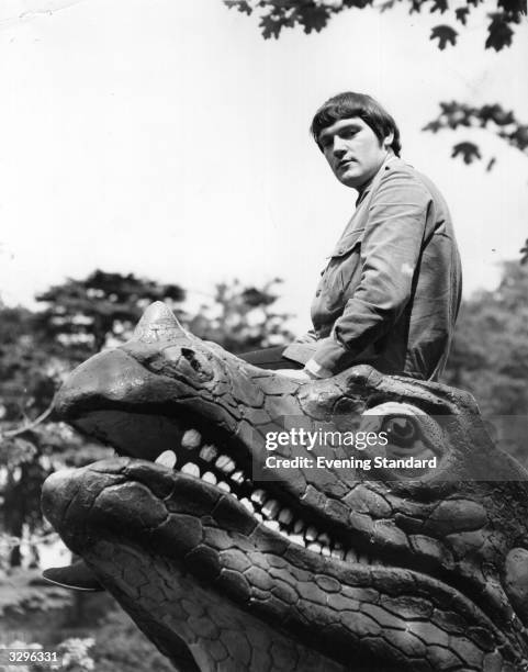 British jazz rock organist Brian Auger, whose group Trinity currently includes vocalist Julie Driscoll, perches calmly on the head of a model...