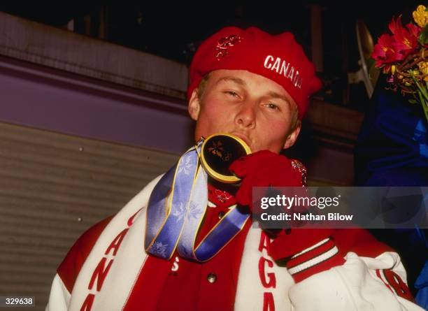 Ross Rebagliati of Canada kisses his gold medal during the snowboard medal ceremony during the 1998 Winter Olympic Games in Nagano, Japan. Rebagliati...