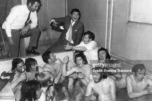 The Birmingham City team celebrate a win with champagne in the bath.