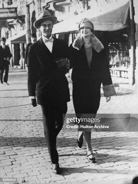 King Leopold III of Belgium walking in the street with Queen Astrid .