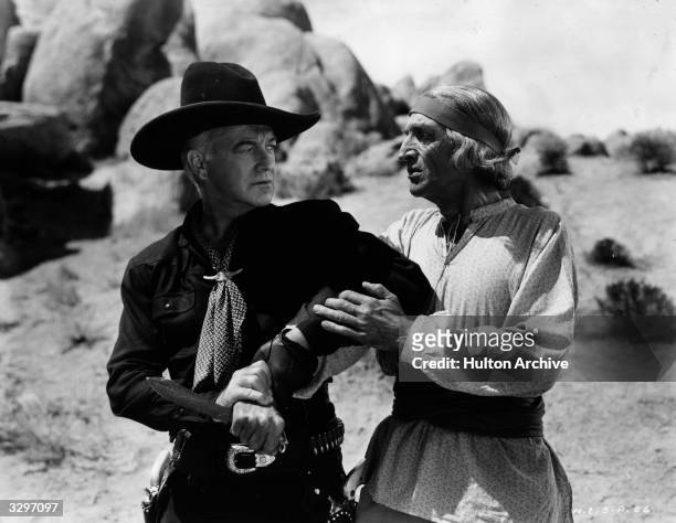 William Boyd as Hopalong Cassidy and Fritz Leiber as Chief Keoli in the film 'Dangerous Venture', directed by George Archainbaud for United Artists.