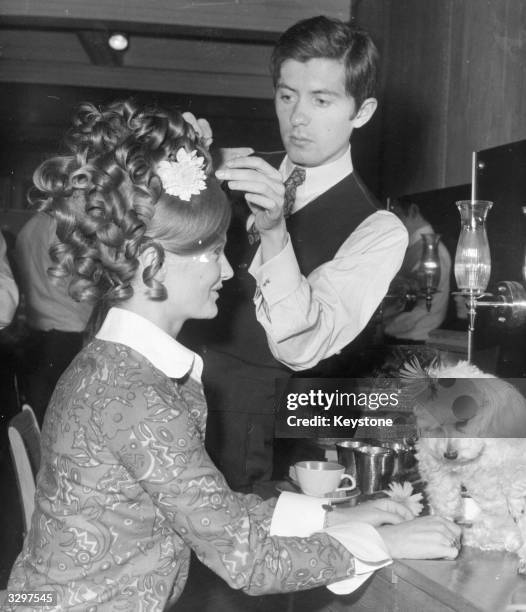 Monsieur Christophe of the famous Parisian house of Xirhodes, at work in their first London salon in Bruton Street, on a coiffure for actress Anna...