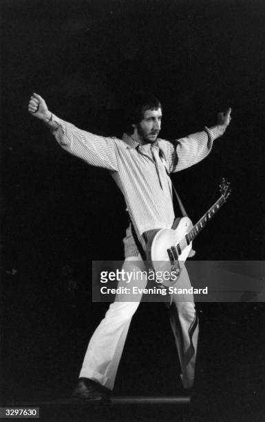 Pete Townshend songwriter and guitarist with British rock group The Who, performing on stage.