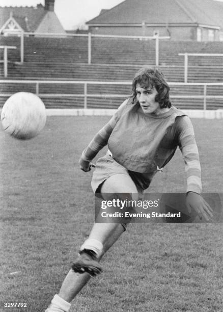 Footballer Ken Hill of Gillingham FC kicks ball.