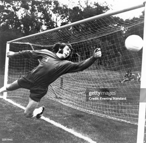 Footballer Pat Jennings of Tottenham Hotspur dives for a ball.