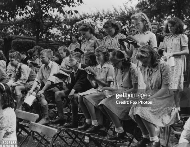 Schoolchildren studying the script of 'A Midsummer Night's Dream' during the first open air television production at Regents Park.