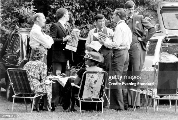 Group enjoys time off from the racing for a picnic in the car park in Ascot.