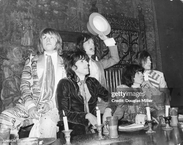 British rock group the Rolling Stones in the Elizabethan Room at Gore Hotel, Kensington, where they held a beggars banquet, complete with serving...