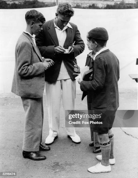 Kent and England cricketer Arthur Fagg signs children's autographs at Dover. Cricket umpire .