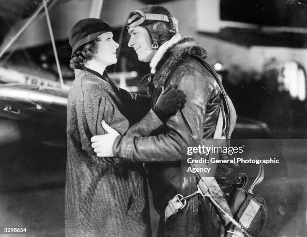 Actor William Gargan plays a pilot about to take to the sky, engaged in a fond farewell with Myrna Loy in the film 'Night Flight'. Title: Night...