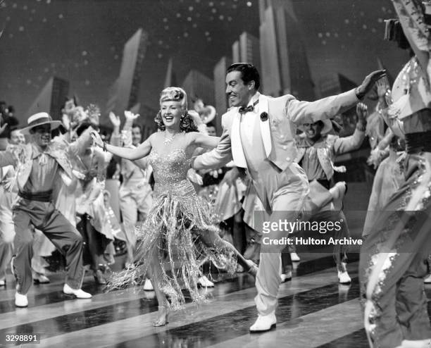 American pin-up Betty Grable and Cesar Romero perform a song-and-dance number from the musical 'Springtime In The Rockies', directed by Irving...