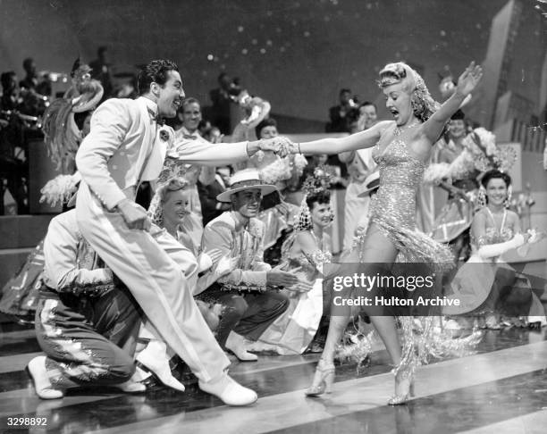 American pin-up Betty Grable and Cesar Romero perform a song-and-dance number from the musical 'Springtime In The Rockies', directed by Irving...