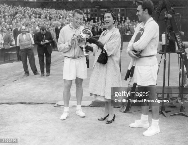 Marina, Duchess of Kent, presents the Wimbledon men's singles trophy to Tony Trabert of the USA after he beat Kurt Nielsen of Denmark in three sets.