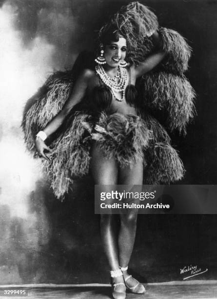 American singer and exotic dancer Josephine Baker , of the Parisian Folies Bergere, poses in one of her many elaborate costumes.