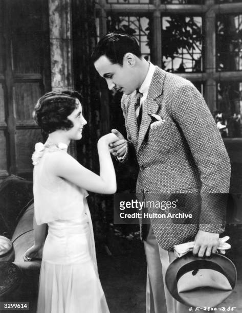 Rod La Rocque , formerly Roderick La Rocque De La Rour is kissing the hand of Betty Bronson the American leading lady in a scene from 'The Locked...
