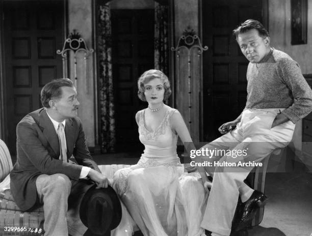 Actress Constance Bennett , her father Richard Bennett and director Edmund Goulding meet and talk on the set of their latest film 'Sally, Irene and...