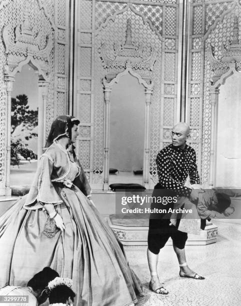 Deborah Kerr as the governess is being introduced to the children of the palace by Yul Brynner who is playing their father, the King of Siam in a...