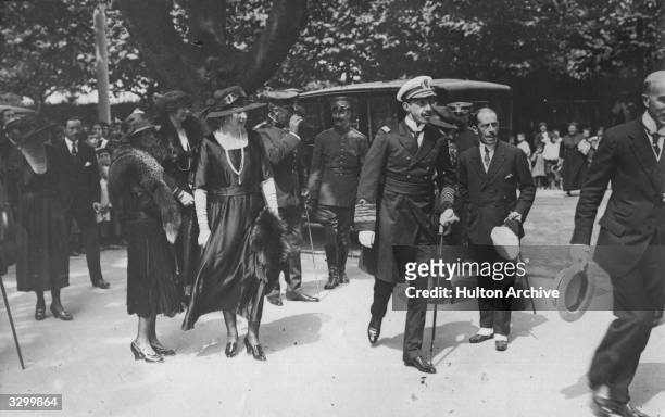 King Alfonso XIII of Spain, , king from 1886 to 1931, , walks with his wife Queen Victoria Eugenie of Spain, , , in the public gardens in Bilbao.