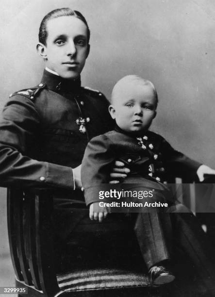 King Alfonso XIII of Spain, , with his eldest son and heir Alfonso, Prince of Asturias . The prince is wearing the uniform of a private in the King's...