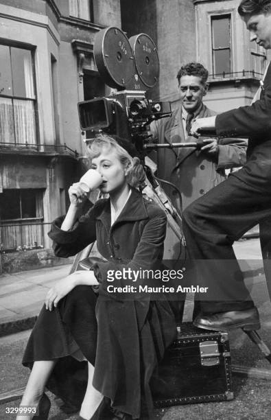 British actress Pauline Stroud drinking a cup of tea between shots during the British Lion production of 'Lady Godiva Rides Again' on location at...