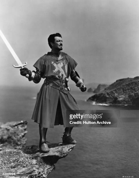 Robert Taylor the stage name of Spangler Arlington Brugh, plays the part of Lancelot who is about to throw Excalibur, the sword of King Arthur, into...