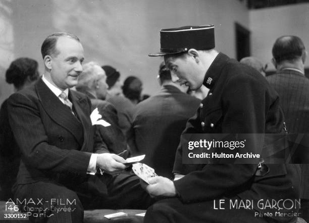 Card trick surprises a fat policemen in a scene from the film,' Le Mari Garcon', directed by Alberto Cavalcanti for Amax Films.