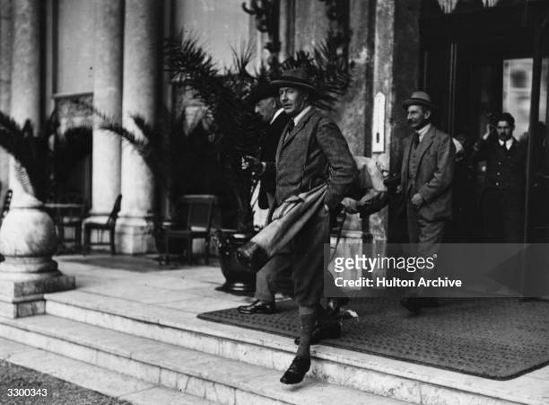The 2nd Duke of Westminster, Hugh Richard Arthur Grosvenor leaves his hotel in Biaritz to play a round of golf, probably at Pau.