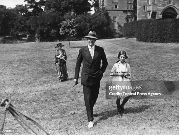 The 2nd Duke of Westminster, Hugh Richard Arthur Grosvenor (1879 - 1953 seen here with his second daughter at a presentation ceremony.