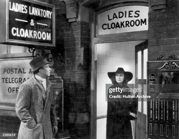 Valerie Hobson enters a Ladies Cloakroom while Conrad Veidt waits outside, in a scene from 'Contraband' , directed by Michael Powell and produced by...