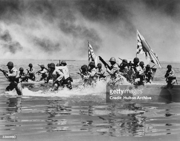 An action shot from the film 'Wake Island' where marines fight to hold an American base on a Pacific Island during World War II. The film was...