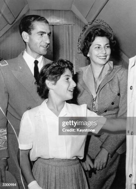 Mohammed Reza Pahlavi, Shah of Iran, with his wife Soraya, Queen of Persia and daughter Princess Shahnaz at the airport at Tehran, bound for...