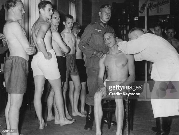 Young conscripted recruits undergoing a medical examination in Berlin, Germany.